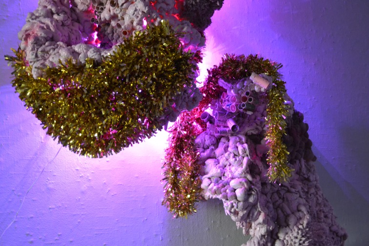 Lump #1 (Detail) 96” x 30” x 9” Insulation foam, handmade pom poms, chicken wire, plywood, LED lights, acrylic paint, craft pom poms, piped latex caulk, plastic curlers, holiday garland 2016